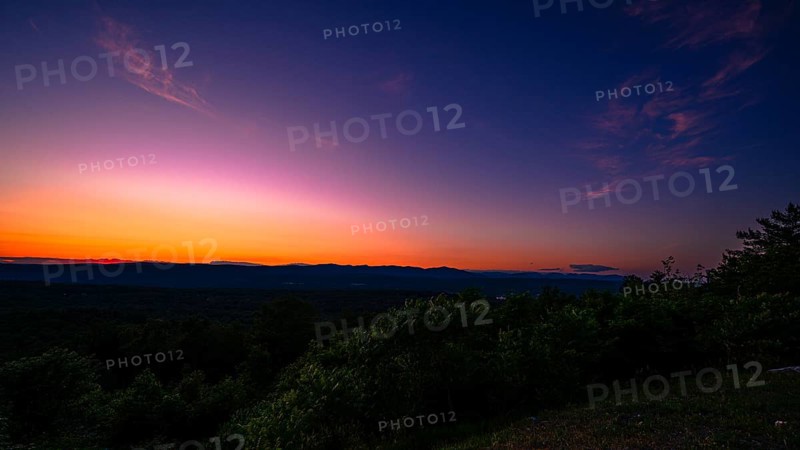 Sun sets behind the Catskills Mountains