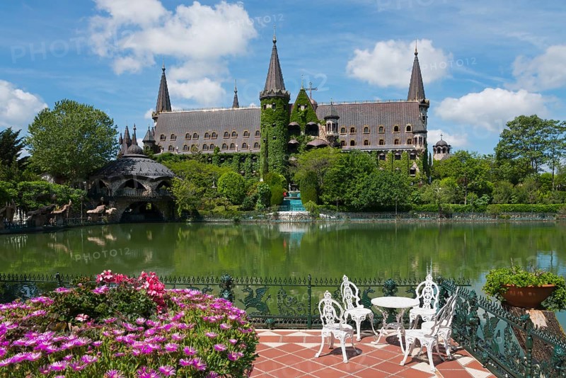 An idyllic castle view with a pond in the foreground