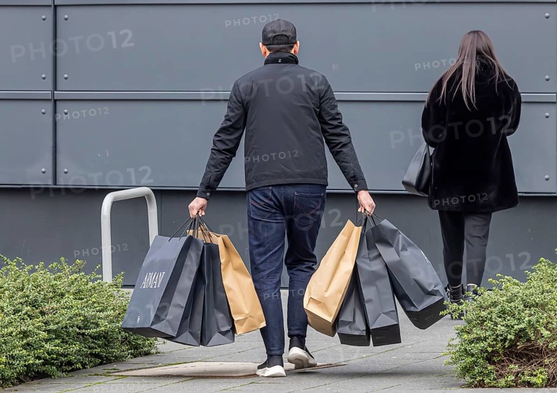 Consumer tourist lugging shopping bags