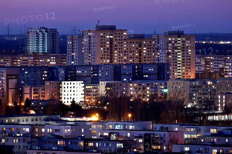 View in the evening at blue hour of high-rise buildings and apartment blocks with rental flats and condominiums in the Berlin district of Marzahn-Hellersdorf