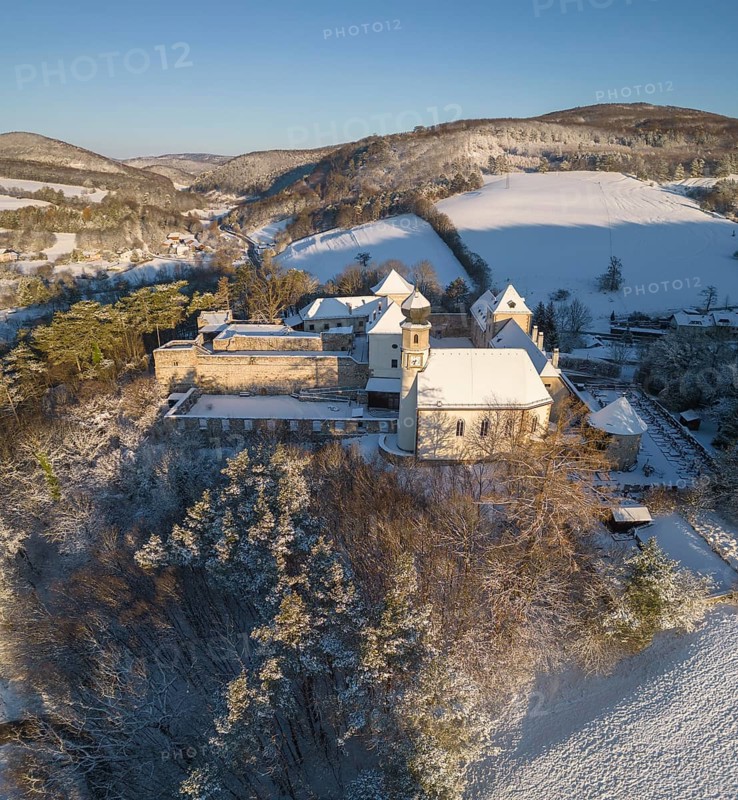 Aerial view of castle and church in winter