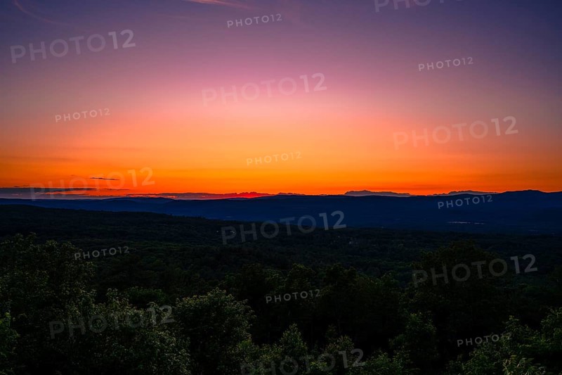 Sun sets behind the Catskills Mountains