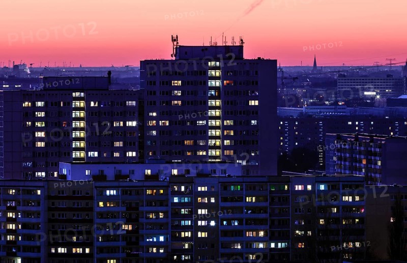 View in the evening at blue hour of high-rise buildings and apartment blocks with rental flats and condominiums in the Berlin district of Marzahn-Hellersdorf