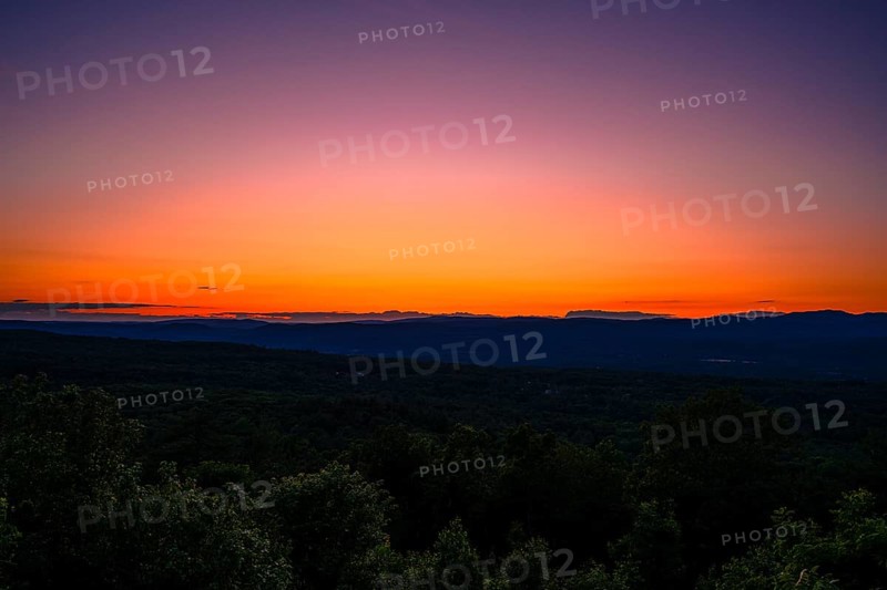 Sun sets behind the Catskills Mountains