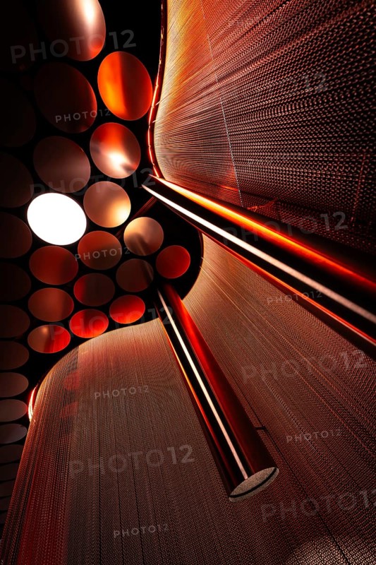Close-up of a red light installation with spheres and reflections