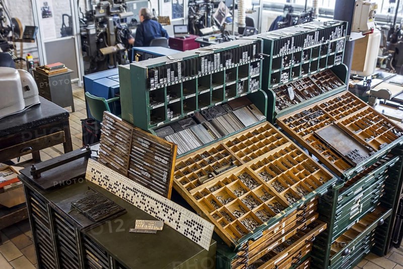Type case in composing room at printing business