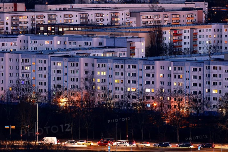 View in the evening at blue hour of high-rise buildings and apartment blocks with rental flats and condominiums in the Berlin district of Marzahn-Hellersdorf