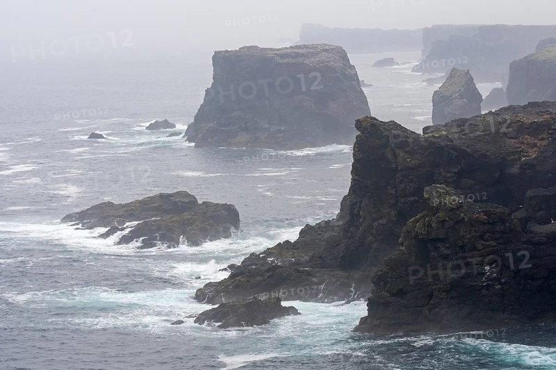 Sea stacks and cliffs in the mist at Eshaness