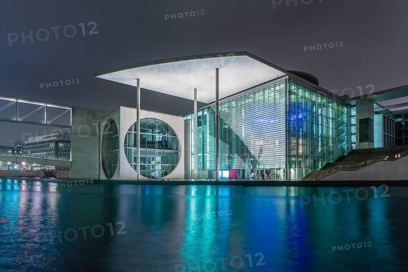 Night view of a government building with water reflection