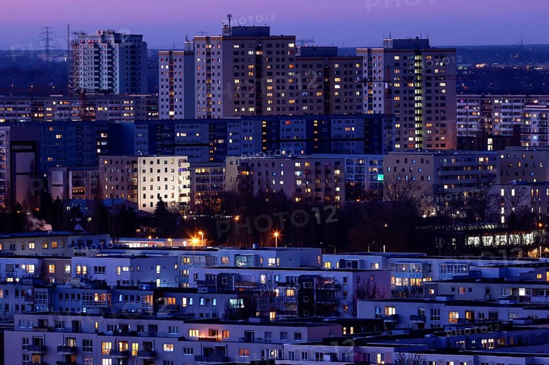 View in the evening at blue hour of high-rise buildings and apartment blocks with rental flats and condominiums in the Berlin district of Marzahn-Hellersdorf