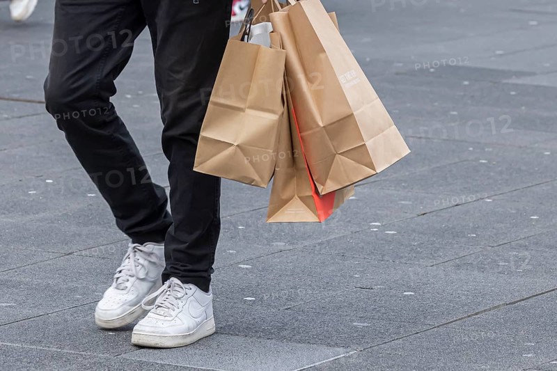 Consumer tourist lugging shopping bags
