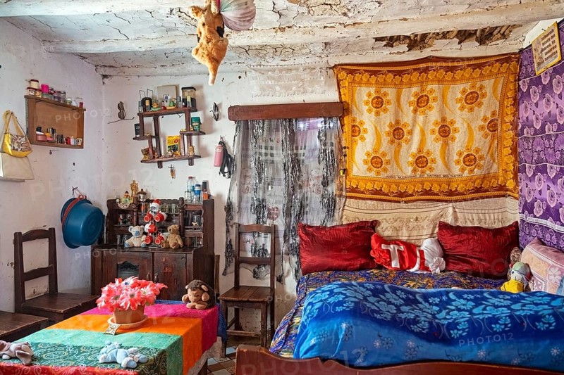 Interior of Betsileo house showing living room with bed in the Haute Matsiatra Region