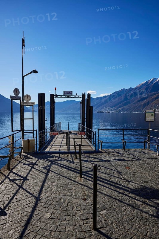 Backlit photograph of the jetty on Lake Maggiore in Ascona