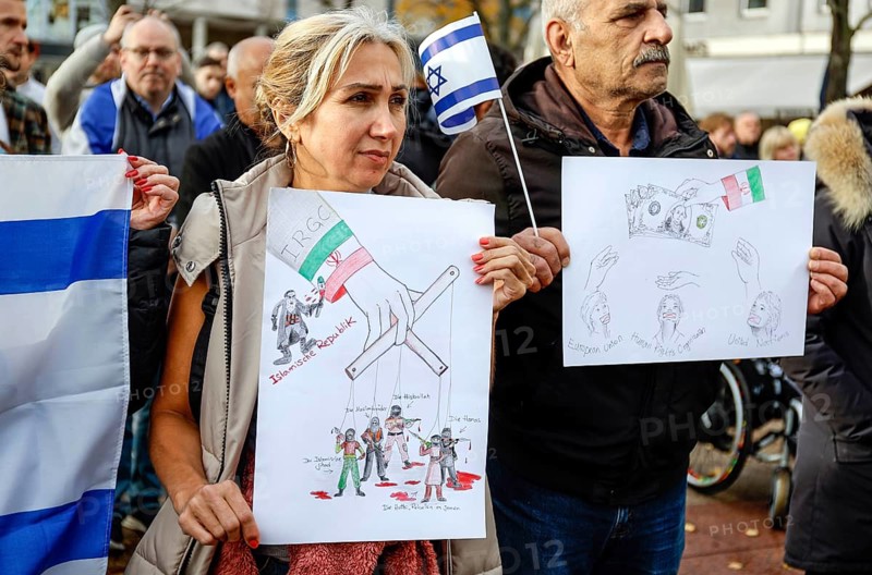 Iranian participants in the demonstration Solidarity March with Israel show posters and Israeli flags