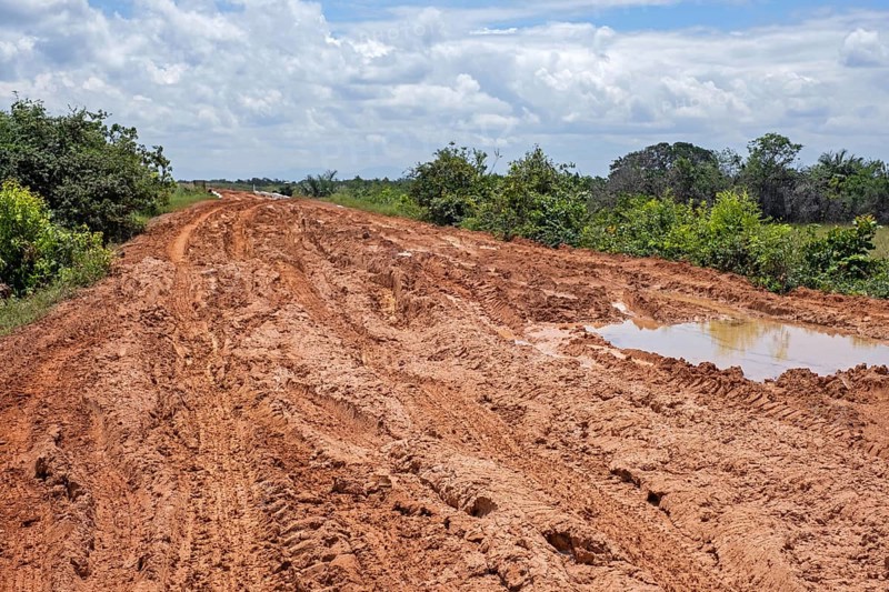 Large rain puddles in red mud of the Linden-Lethem dirt road linking Lethem and Georgetown in the rainy season