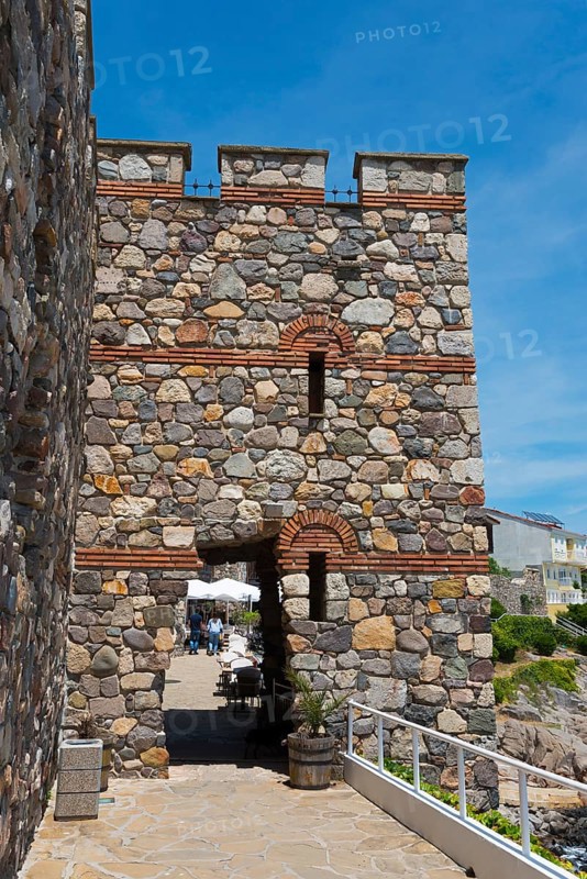 Old stone gate of a fortress under a clear blue sky