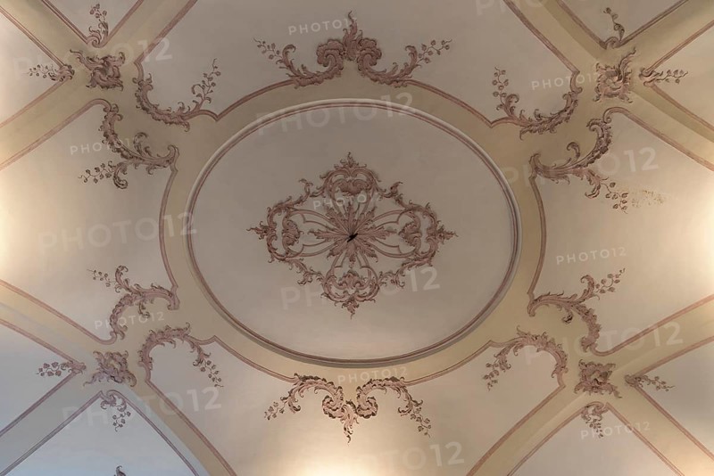 Detailed view of the historic stucco ceiling in the Palazzo Reale