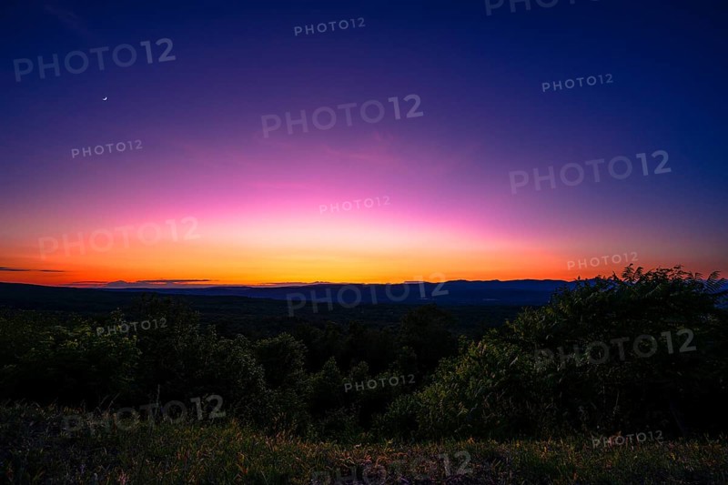Sun sets behind the Catskills Mountains