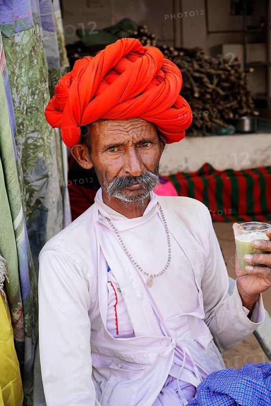 Indian man drinking sugar cane juice