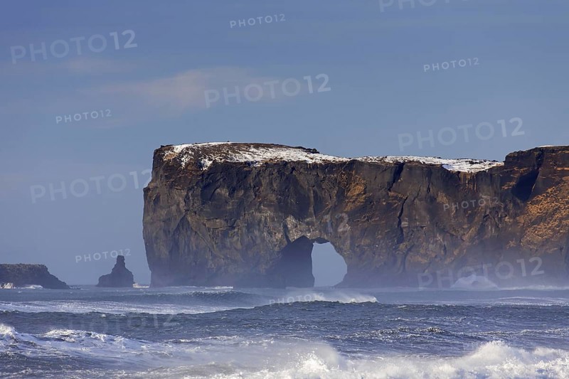 Black arch of lava near Vik i Myrdal at the Dyrholaey peninsula in winter