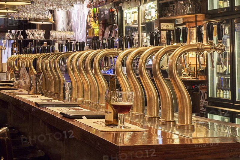 Bar counter showing array of Belgian draught beers served by taps in the Flemish cafe Rock Circus in the city Ghent