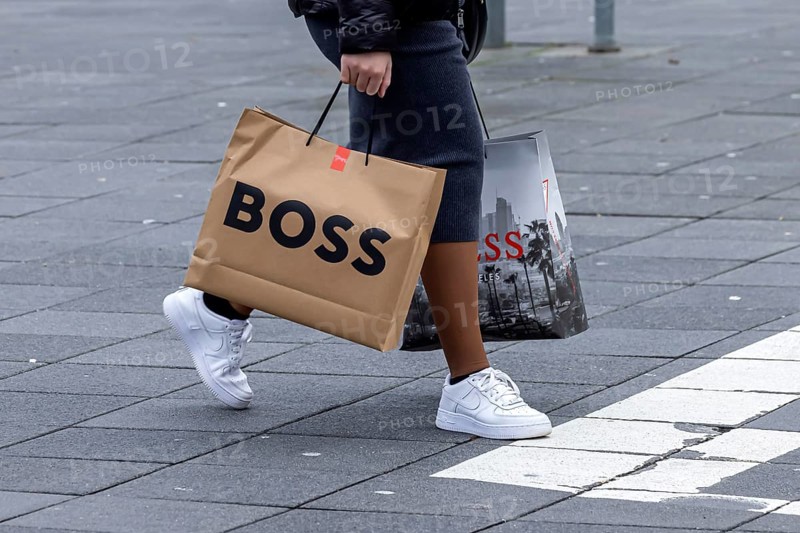 Consumer tourist lugging shopping bags