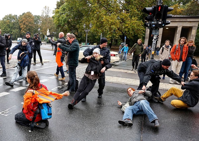 Police officers carry last generation climate activists from Strasse des 17. The Last Generation has called for a mass occupation action