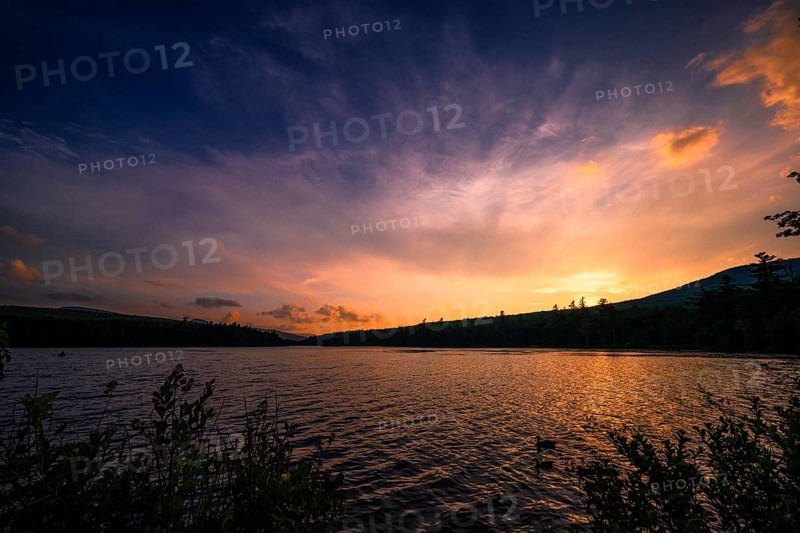 Summer Solstice Sunset on a lake in Catskills Mountains