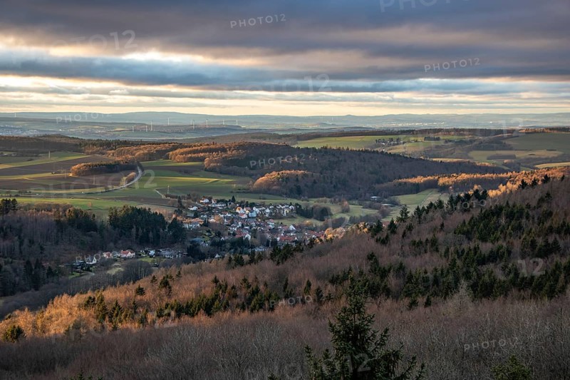 Landscape at the Grosser Zacken, Taunus volcanic region. A cloudy, sunny autumn day, meadows, hills, fields and forests with a view of the sunset. Hesse, Germany, Europe