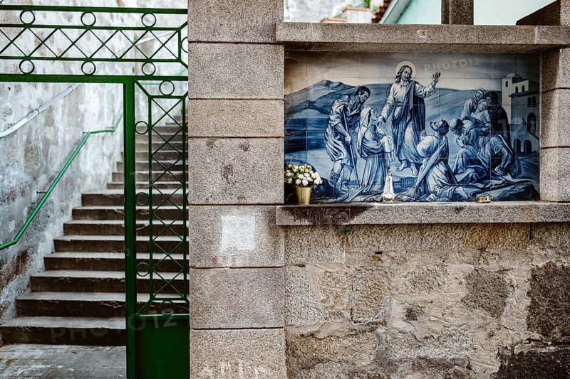 Holy Mary statue with the religious background made of Portuguese traditional tiles, Porto, Portugal, Europe