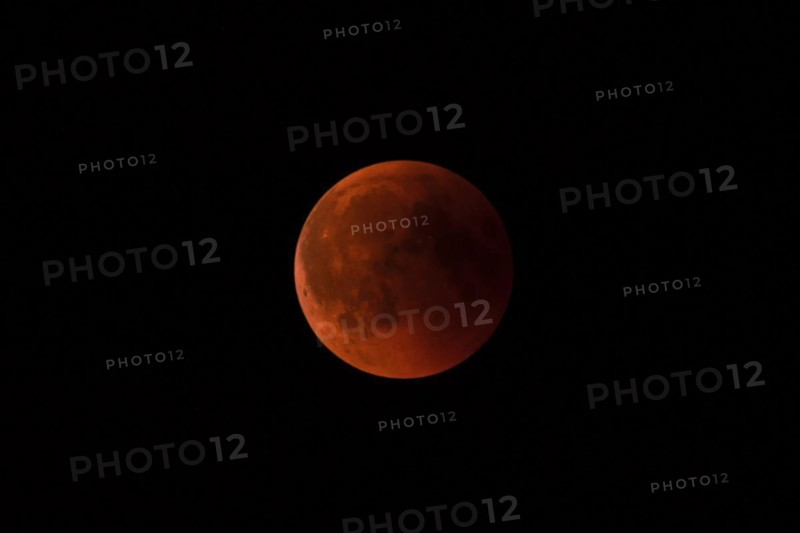 A total lunar eclipse with a reddish moon against a dark sky, Haan, North Rhine-Westphalia, Germany, Europe