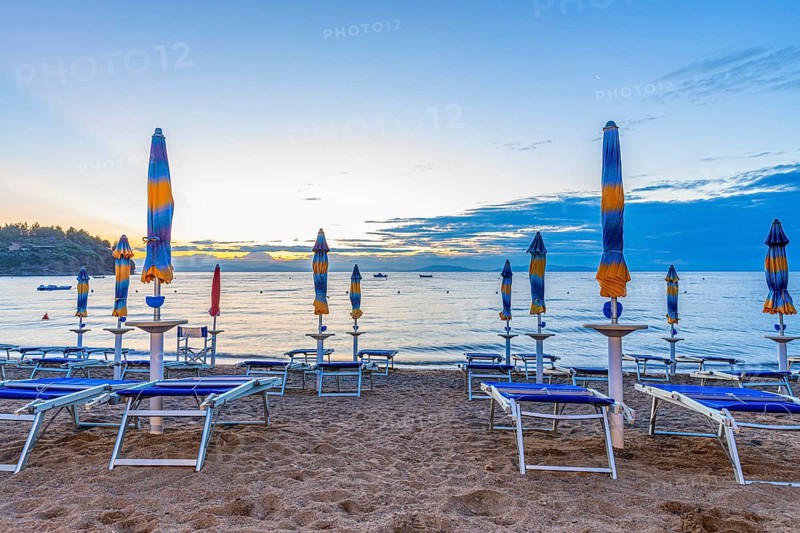 Sun loungers and parasols on Straccolignino beach at sunrise, near Capoliveri, Elba, Tuscan Archipelago, Tuscany, Italy, Europe