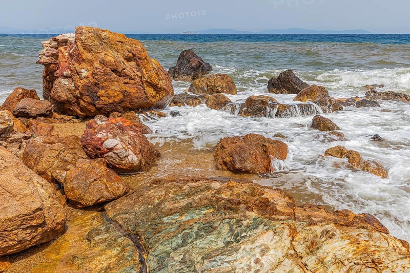 Mineral rocks washed by the sea on the beach of Topinetti, near Rio Marina, Elba, Tuscan Archipelago, Tuscany, Italy, Europe