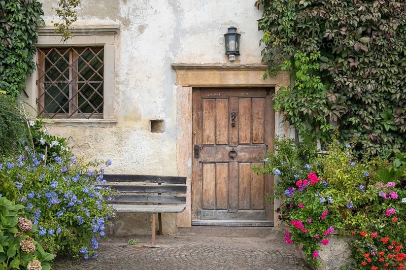 House entrance with lush floral decorations, Mitterdorf, Kaltern, South Tyrol, Trentino-South Tyrol region, Italy, Europe