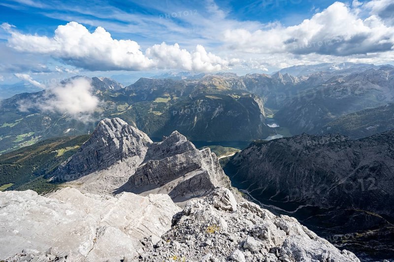 View from the rocky summit of the Watzmann Mittelspitze, view of mountain panorama with Steinernes Meer and Koenigssee, Kleiner Watzmann and Watzmann Kinder, Watzmann crossing, Berchtesgaden National Park, Berchtesgaden Alps, Bavaria, Germany, Europe