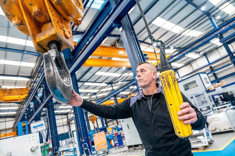 Worker using a huge industrial cane working in a logistics center