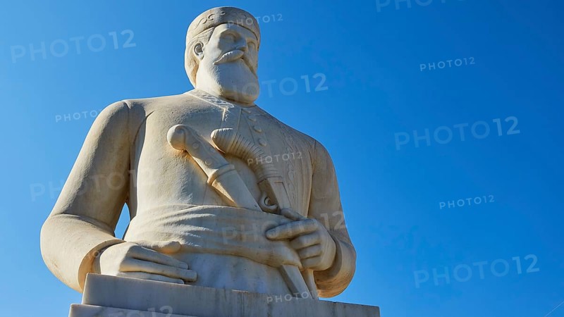 Statue of the resistance fighter and partisan Yannis Daskaloyannis, Imposing statue of a dignified man in front of a bright blue sky, Anopolis, Sfakia, West Crete, Crete, Greece, Europe