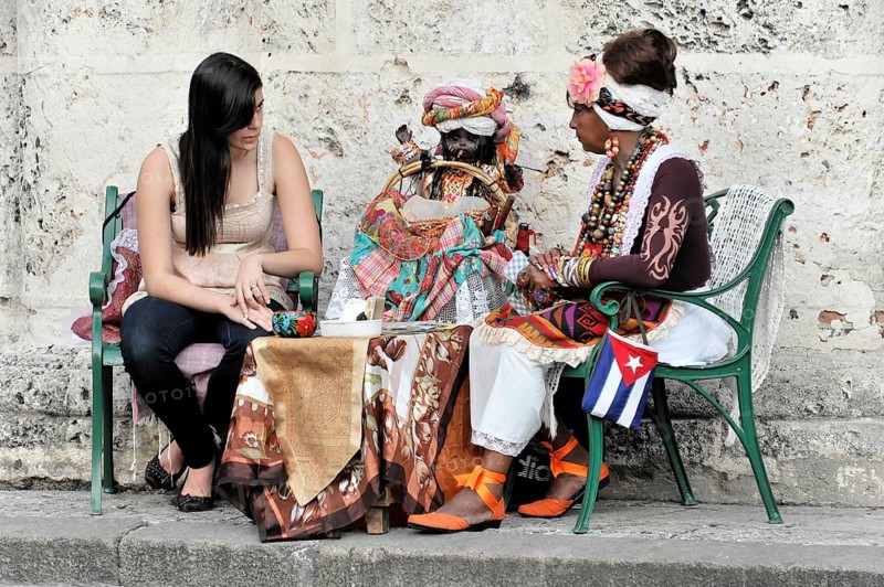 Fortune teller with tourist, Havana, Cuba, Greater Antilles, Caribbean, Central America