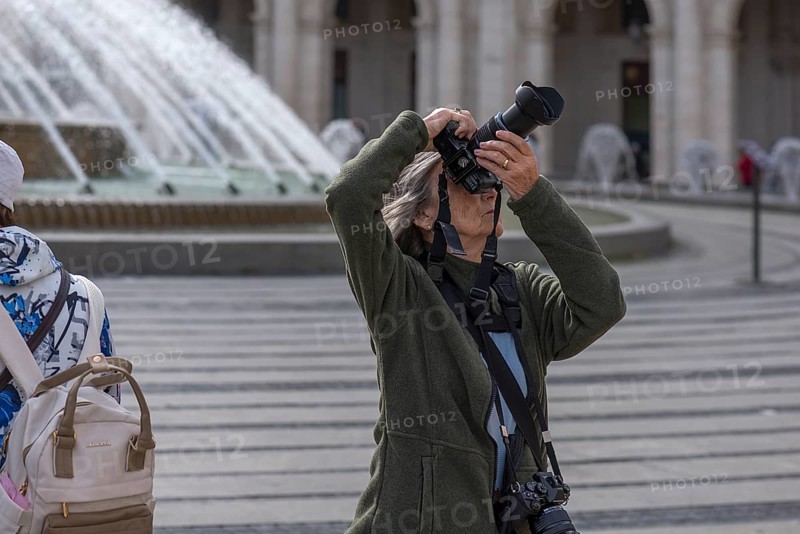 Photographer taking pictures in the Piazza de Ferrari, Genoa, Italy, Europe