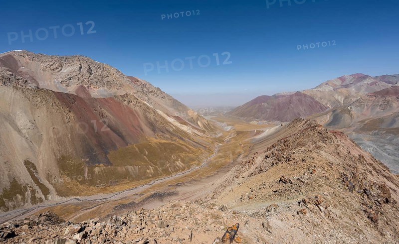 Mountain landscape of glacial moraines, mountains with red and yellow rocks, Traveller's Pass below Lenin Peak, Trans Alay Mountains, Pamir Mountains, Osh Province, Kyrgyzstan, Asia