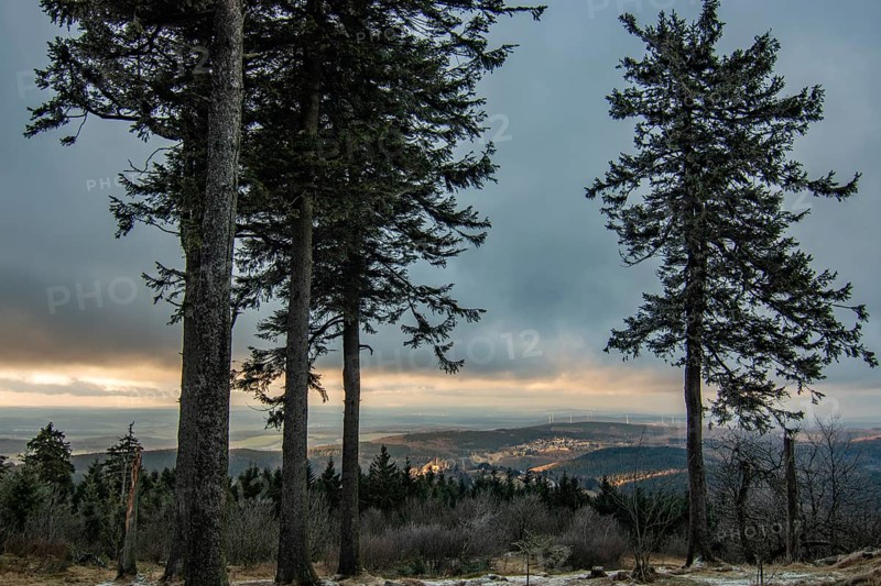 Landscape on the Grosser Feldberg, Taunus volcanic region. A cloudy, sunny winter day, meadows, hills, snow and forests with a view of the winter sunset. Hesse, Germany, Europe