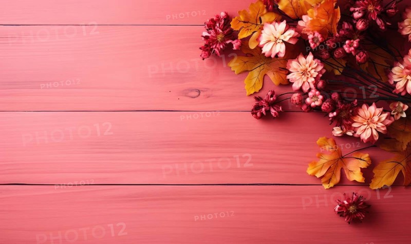 Flat lay of faux autumn leaves and flowers on a pink wooden background AI generated