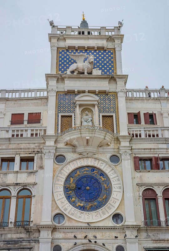 St. Mark Clock Tower (Torre dell Orologio) with Astronomical clock and winged lion statue in San Marco Square, famous tourist attraction in Venice, Italy, Europe