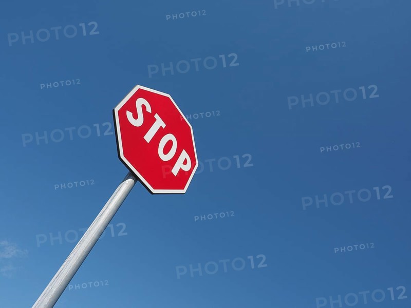 Stop sign over blue sky