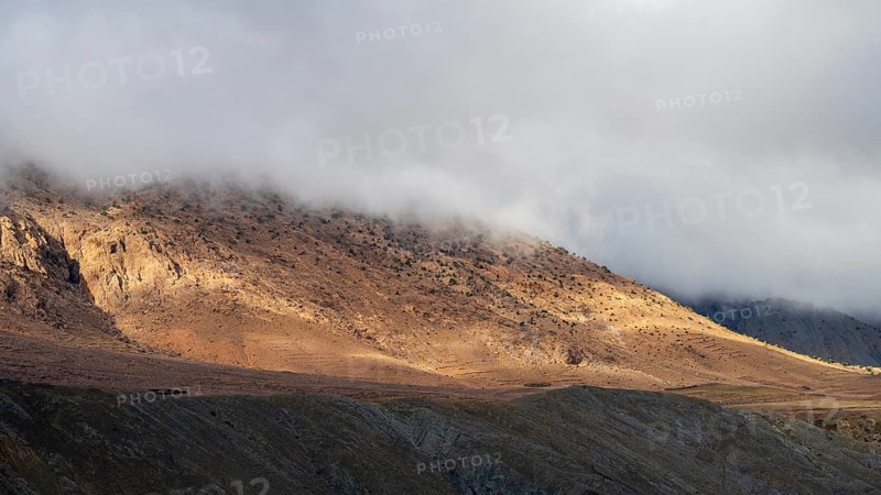 Low hanging clouds in the mountain landscape at the Tizi-n-Tichka pass road, High Atlas, Morocco, Africa