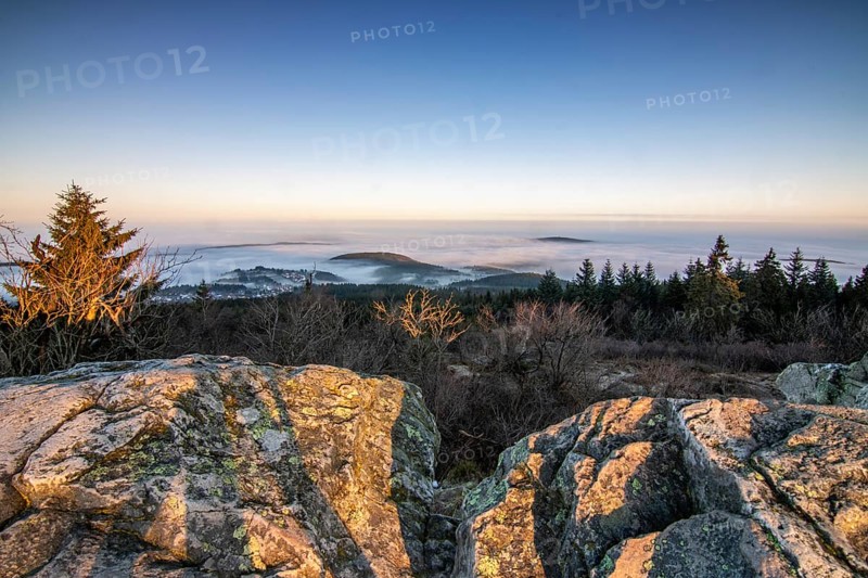 Landscape on the Grosser Feldberg, Taunus volcanic region. A cloudy, sunny winter day, meadows, hills, snow and forests with a view of the winter sunset. Hesse, Germany, Europe