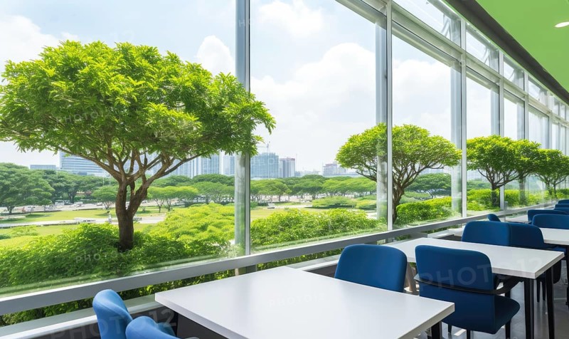 An empty cafeteria with blue chairs and tables overlooking a park through a glass window AI generated