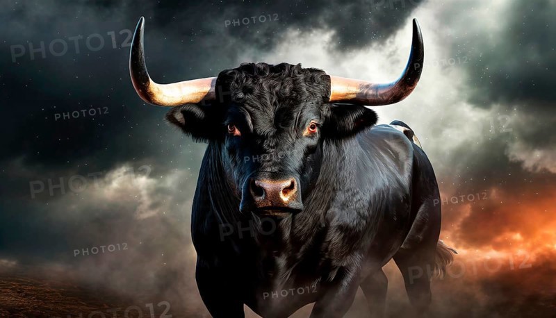 Dangerous black bull with glowing eyes in front of menacing dark clouds and fire, AI generated, AI generated