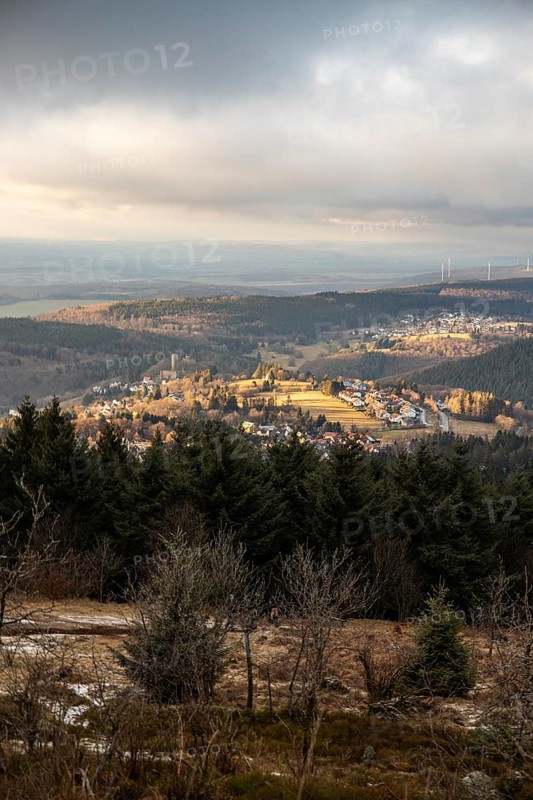 Landscape on the Grosser Feldberg, Taunus volcanic region. A cloudy, sunny winter day, meadows, hills, snow and forests with a view of the winter sunset. Hesse, Germany, Europe