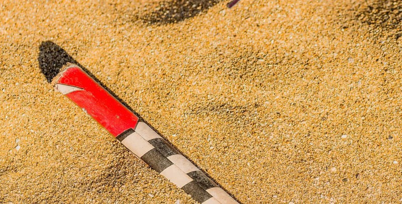 Spend roman candle laying in the sand on a beach